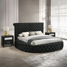 a bedroom with a round bed and black furniture