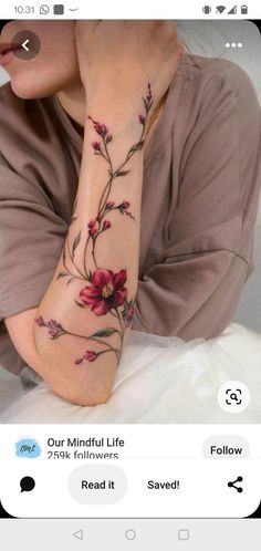 a woman with a flower tattoo on her arm