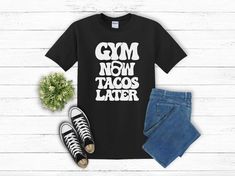 The perfect gym t-shirt for your workout and then getting tacos. This funny workout shirt is for the workout lover who also loves tacos. I mean, who doesn't? Makes a great gift for your favorite gym rat, muscle mommy or taco lover.  🧐Check out our other designs🧐 🔎Product details and sizing🔎 - Gildan 5000 Heavy Cotton Unisex T-Shirt - 100% cotton (fiber content may vary for different colors) - Comes in 8 colors: Black, Dark Chocolate, Cardinal Red, Royal Blue, Dark Heather Grey, Maroon, Turf Funny Letter Print Gym Tops, Casual Gym T-shirt With Screen Print, Funny Text Crew Neck Gym Top, Funny Text Crew Neck Top For Gym, Graphic Tee With Slogan For Gym, Sporty Tops With Funny Text For Workout, Black Gym Tops With Funny Text, Black Gym Top With Funny Text, Sporty Workout Tops With Funny Text