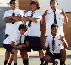 four boys in school uniforms posing for a photo