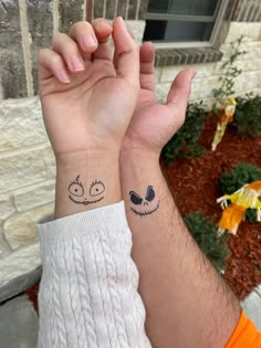 two people with matching tattoos on their wrists