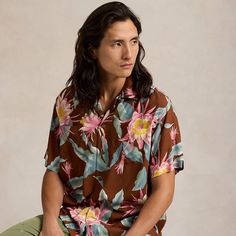 This shirt is a part of a special collaboration between Polo Ralph Lauren and Hoffman Fabrics. The original pattern was sourced from the personal archive of Mr. Walter Hoffman whose iconic tropical-print textiles have been a staple of modern surfwear since the 1950s. It was then updated specifically for us to make it distinctly Polo. Relaxed Fit Camp Shirt With All-over Print, Tropical Relaxed Fit Camp Shirt With All Over Print, Tropical Camp Shirt With All Over Print, Casual Vintage Print Camp Shirt For Vacation, Retro Hawaiian Shirt With Camp Collar, Tropical Tops With Camp Collar And All Over Print, Casual Camp Shirt With Vintage Print In Relaxed Fit, Casual Camp Shirt With Vintage Print And Relaxed Fit, Brown Camp Collar Top For Beach