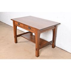 a small wooden table with two drawers on one side and a shelf on the other