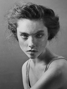 a black and white photo of a woman with freckled hair