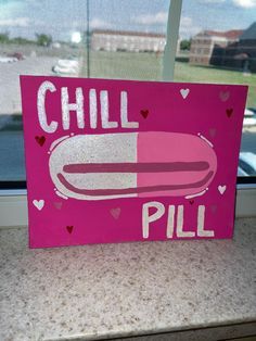 a pink sign that says chill pill on it