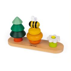 a wooden toy with a bee sitting on top of it