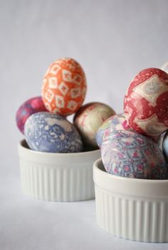 several colorful decorated eggs in a white bowl