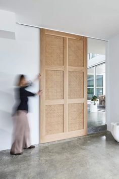 a woman standing in front of a wooden door