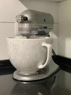 a white mixer sitting on top of a counter