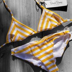 Emerson Triangle Top Yellow And White Ribbed Fabric Top Ties At The Neck & Back Gold Bb Ends Angela Bottom Skimpy Coverage W/ Full Shirring Signature Bb Nameplate Mustard Swimwear For Summer Poolside, Mustard Swimwear For Beach Season, Mustard Swimwear For Poolside In Summer, Mustard Swimwear For Summer Beach, Mustard Swimwear For Poolside And Beach Season, Fitted Mustard Swimwear For Summer, Mustard Fitted Swimwear For Summer, Mustard Swimwear For Vacation Beach Season, Mustard Beachwear Swimwear For Vacation