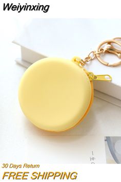 a yellow round keychain sitting on top of a white table