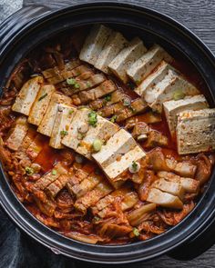 Clay pot filled with braised kimchi (kimchi jJim) Tofu Pork Belly, Braised Kimchi, Kimchi Jjim, Korean Pork Belly Recipes, Tofu Kimchi, Pork Belly Strips, Easy Recipies, Aesthetic Foods