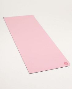 a pink yoga mat sitting on top of a white table