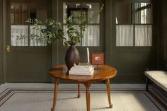 a table with a vase and books on it