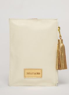 This bag is made from high-quality, super-soft ivory leather sourced from a premiere hide house in California. The leather is shipped to New York City, where our bags are produced by expert craftsmen and finished with a smooth zipper, leather tassel, and metal ring. Just big enough for all your essentials, we designed the Ring Wristlet to be your go-to bag for going out! Whether you’re heading to a cocktail party, a concert, or out on the town, slip it on your wrist so your hands are free for si House In California, Book Table, Shoe Gifts, California Homes, Big Bags, Vacation Style, Metal Ring, Leather Tassel, Bag Dress