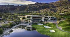 an aerial view of a golf course surrounded by mountains