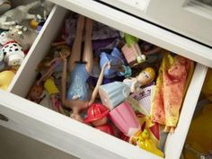 toy figurines and other toys are stored in an open drawer