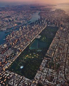 an aerial view of a city with lots of tall buildings and water in the foreground