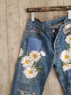 an old pair of jeans with flowers painted on them