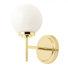 a wall light with a white glass ball on the top and gold metal arm, against a white background