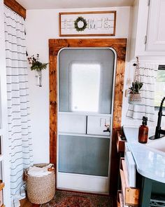 a door is open in a kitchen with a rug on the floor next to it