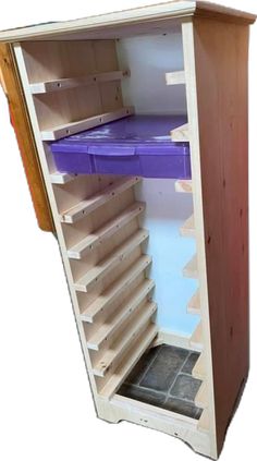 an open wooden cabinet with shelves and purple trays on the bottom shelf, against a white background