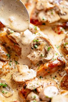 a spoon is being drizzled with sauce over some meats and mushrooms