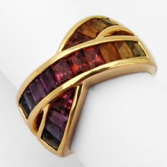 Vintage 18 K (.750) yellow gold crossover design band ring, decorated with multi-gemstones, creating a rainbow look - Peridot, Citrine, Garnet, Amethyst and Topaz. This amazing colorful ring is a size 7, 11.8 mm wide and weighs 8.4 grams. EA1407 Colorful Ring, Antique Jewelry Rings, Green Garnet, Yellow Gold Bracelet, Color Ring, Multi Stone, 7 11, Gold Bands, Vintage Watches