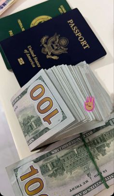 several different types of money sitting next to each other on top of a white table