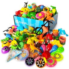 a box filled with lots of assorted toy items on top of a white surface