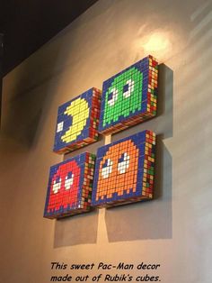 three pieces of art made out of legos hanging on the side of a wall