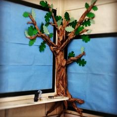 a tree made out of paper sitting on top of a desk