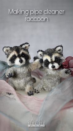 two stuffed raccoons sitting next to each other on a cloth covered surface with text reading making pipe cleaner raccoon