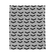 a black and white towel with bats printed on the front, in an abstract pattern