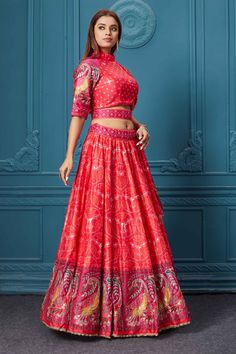 Dance like a diva on sangeet, mehendi, and wedding in this gorgeous red bandhej print silk lehenga with gotta patti work and beautifully decorated borders. Featuring with a beautiful high neck and 3/4th sleeve blouse. Shop online at Pure Elegance or visit our store in the USA. Red Bandhani Print Choli For Diwali, Red Bollywood Choli With Bandhani Print, Semi-stitched Red Choli With Bandhani Print, Red Bandhani Print Art Silk Sharara, Red Bandhani Print Lehenga For Festivals, Red Bandhani Print Choli For Wedding, Red Bandhani Print Sharara In Art Silk, Fitted Red Choli With Gota Work, Fitted Bandhani Print Lehenga For Reception