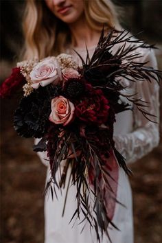 a woman holding a bouquet of flowers in her hands