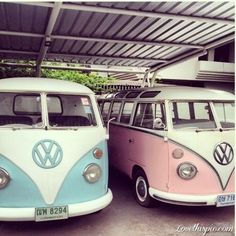 two vw buses are parked next to each other