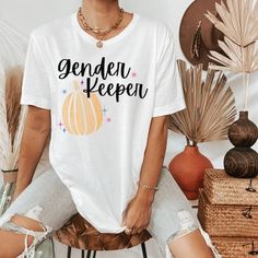 a woman sitting on top of a chair wearing ripped shorts and a t - shirt that says all natural