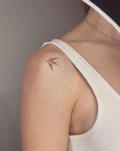 a woman with a small tattoo on her shoulder