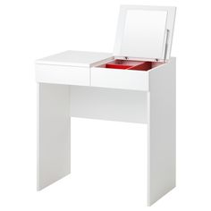 a white dressing table with a mirror and drawers on it's sides, open to reveal a red drawer