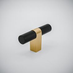 a black and gold colored object on a white background with no one around it or someone else