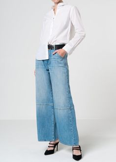 These voluminous yet supple wide leg jeans boast an artfully spliced silhouette and a medium light blue wash in a rigid soft denim fabric for a luxurious look. Model is 5'10" wearing size 26. Approx. Front rise: 11.5" Inseam: 30.5"Approx. Knee: 23.25" Leg opening: 22.5" 100% CottonMade in USA Fits true to size. Baggy Shorts, Jumpsuit Jacket, Kick Flares, Independent Designers Fashion, Denim Top, Denim Fabric, Men's Collection, Price Match, Wide Leg Jeans