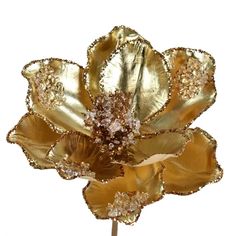 a gold flower is shown on a white background