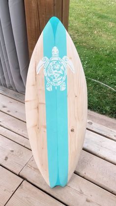 a surfboard sitting on top of a wooden deck