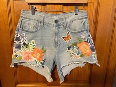 Upcycled cut off shorts with floral handmade patchwork. One of a kind pair! This design is available for made to order requests. We just ask that you send us your shorts or message us we might have your size in stock! Summer Denim Bottoms With Floral Patchwork, Summer Patchwork Cutoff Jean Shorts, Patchwork Cutoff Jean Shorts For Summer, Summer Denim Jean Shorts With Patches, Summer Cutoff Jean Shorts With Patches, Cutoff Denim Shorts With Patches, Cotton Jean Shorts With Patches For Summer, Spring Cotton Jean Shorts With Patches, Spring Shorts With Patches