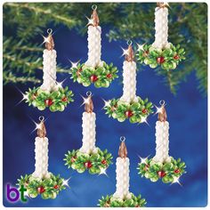 six christmas candles hanging from a tree with holly wreaths and bells around them on a blue background