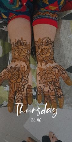 the hands and feet of a woman with henna designs on their palms are shown