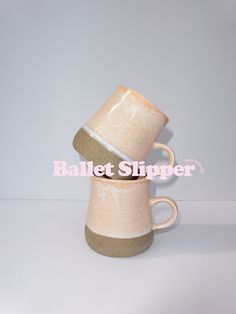 two coffee mugs stacked on top of each other with the words ballet slipper