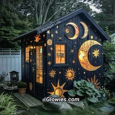 a small house with the moon and stars painted on it