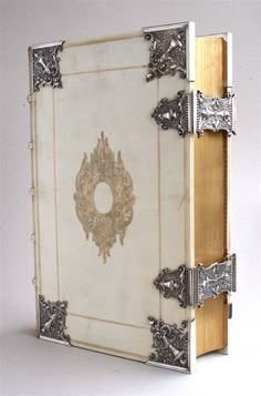 an open book with ornate designs on the cover